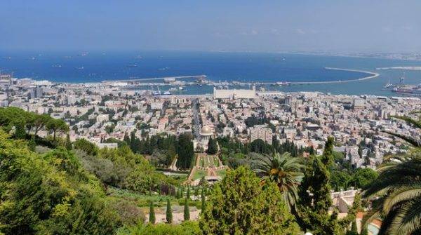 Stunning aerial view of Haifa, Israel, featuring the Baha'i Gardens and the Mediterranean Sea.
