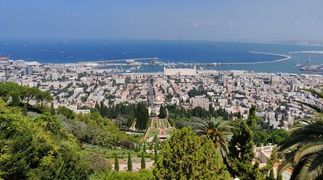 Stunning aerial view of Haifa, Israel, featuring the Baha'i Gardens and the Mediterranean Sea.